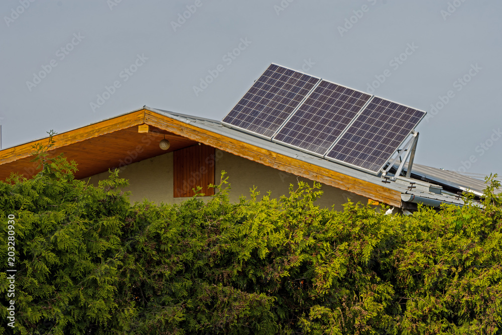 green energy, solar panels on the roof of a family house green energy, solar panels on the roof of a family house