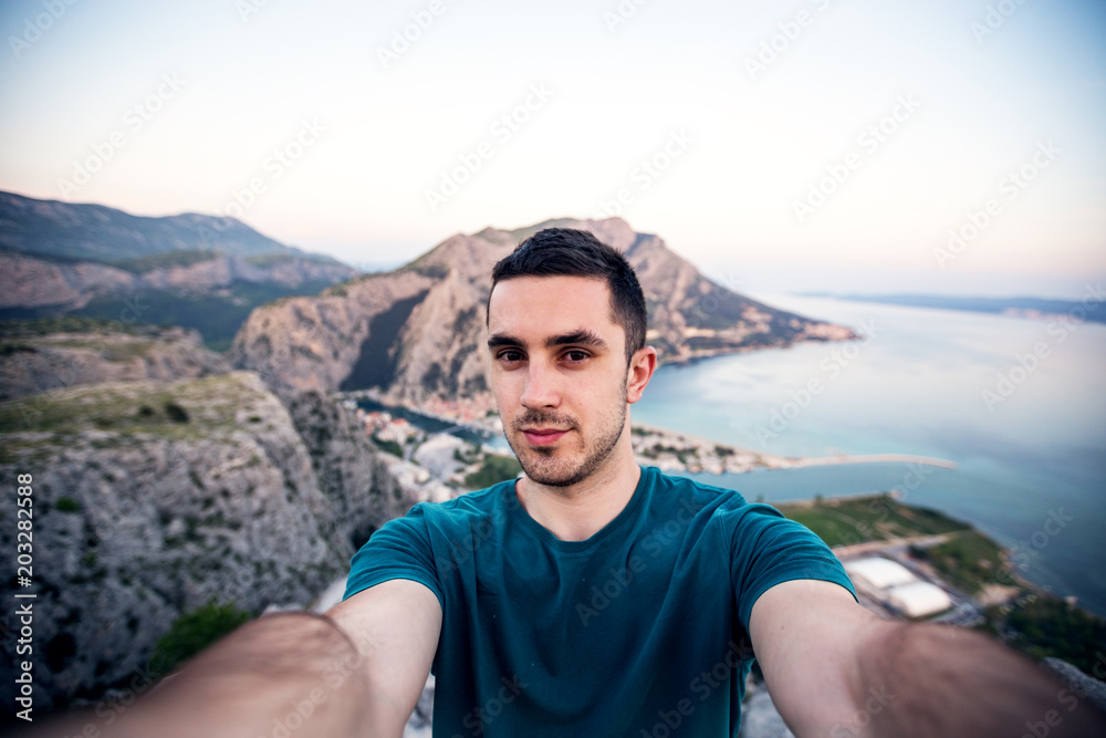 Handsome young man doing selfie outdoor