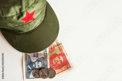 Cuban pesos with heroes icon of Guevara and Cienfuegos and military cap photo