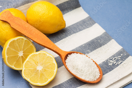 Lemons and citric acid in a wooden spoon