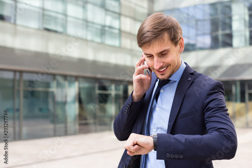 Businessman talking on the phone  outside
