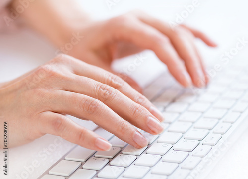 Woman s hands typing on keyboard