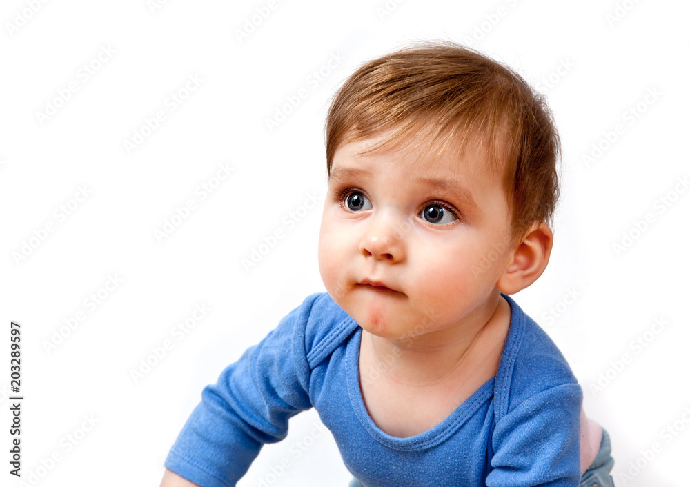 Portrait of a little boy in a blue shirt on a white background