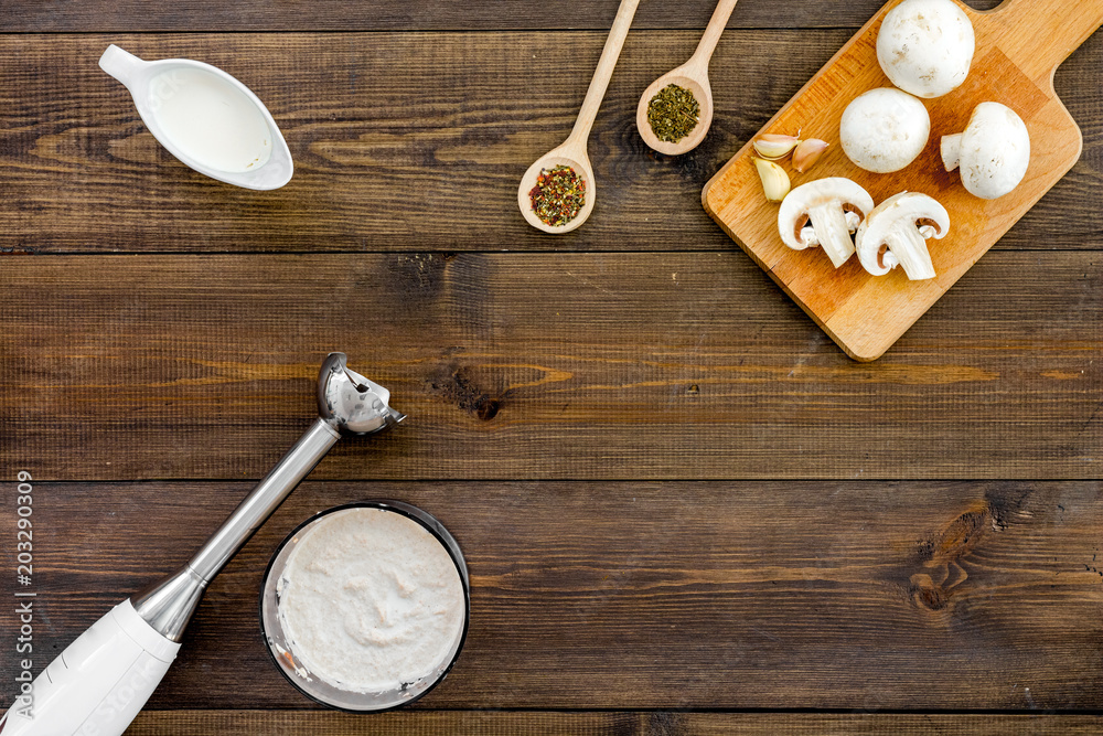 Cook cream soup with mushrooms. Champignon, cream, spices and blender on dark wooden background top view copy space Cook cream soup with mushrooms. Champignon, cream, spices and blender on dark wooden background top view copy space