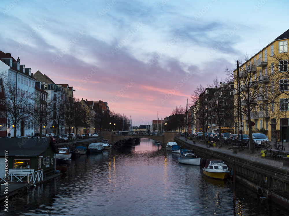 Sunset at the Copenhagen canals at Christianshavn, with colorful sky and twilight