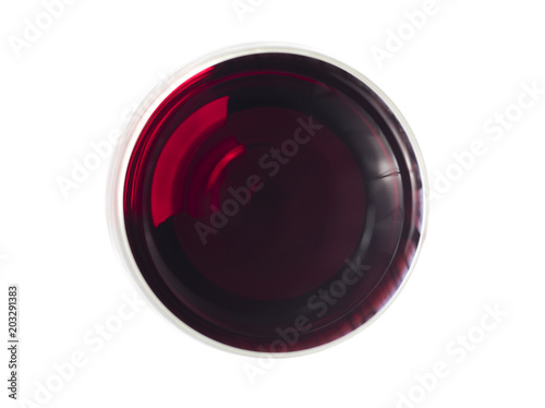 Glas of red wine pictured from above on white surface
