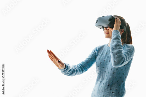 A young beautiful woman in glasses of virtual reality saw something amazing. Modern technologies.