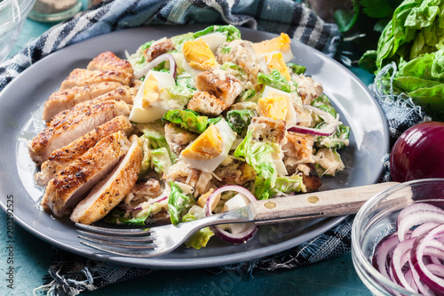 Healthy caesar salad with chicken, eggs and croutons
