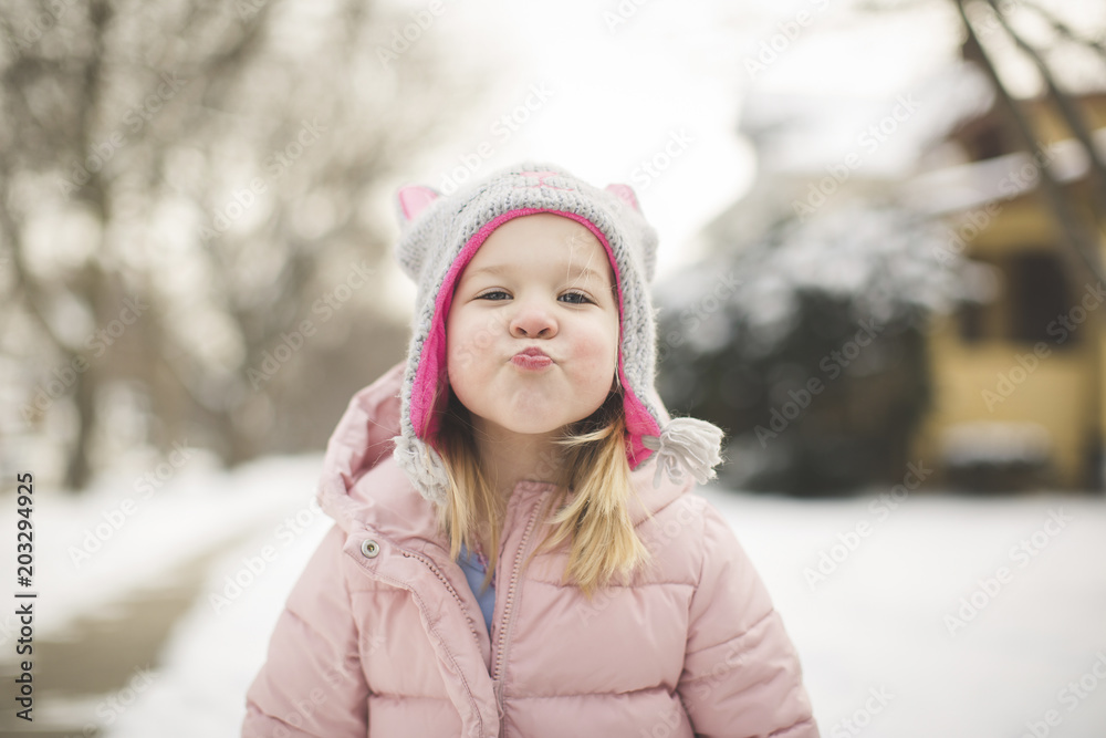 Portrait of cute girl puckering while wearing warm clothing during winter Portrait of cute girl puckering while wearing warm clothing during winter