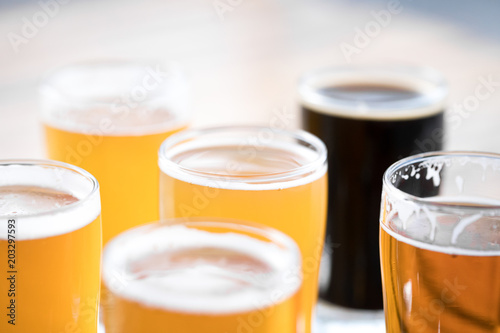 Close up on a flight of craft beer in pint glasses with space for text 