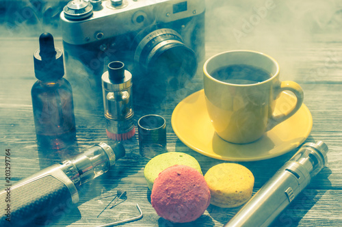 Still life with e-cig and jiuce on the wooden background photo