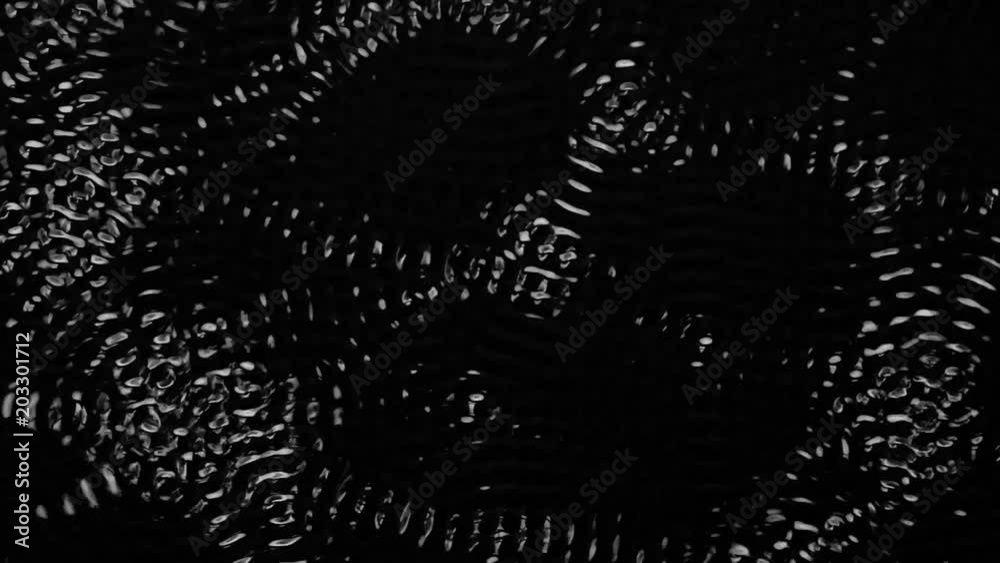 Sound vibration depicting an abstract water shapes. Black background. Slow motion