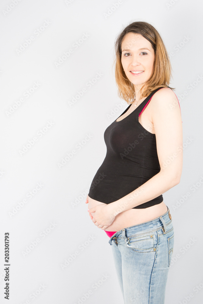 Portrait of a pregnant woman isolated over gray background