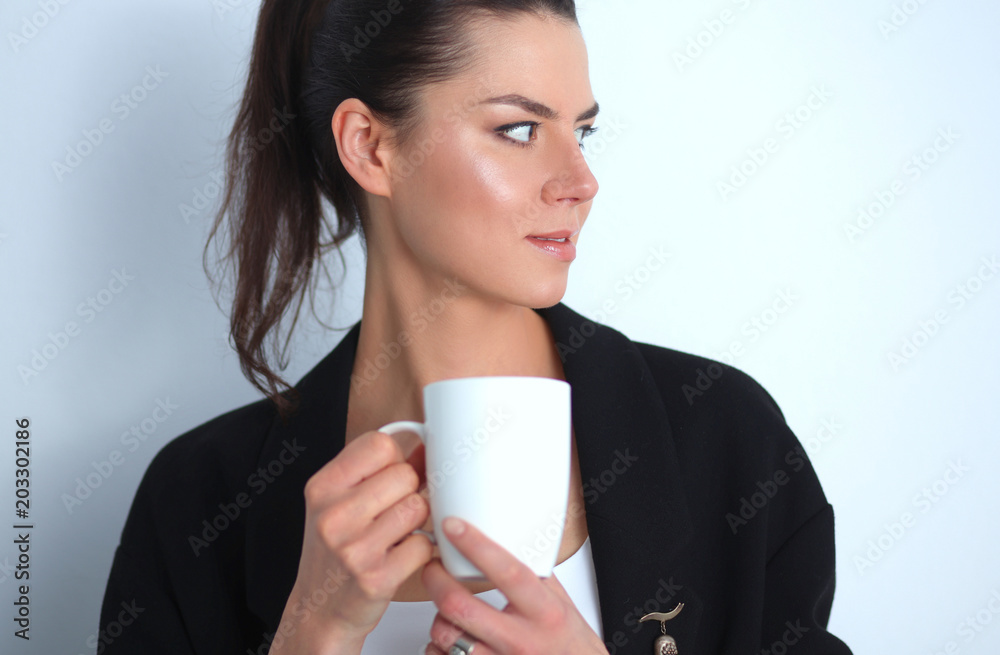 Young woman holding a mug, isolated on white background Young woman holding a mug, isolated on white background