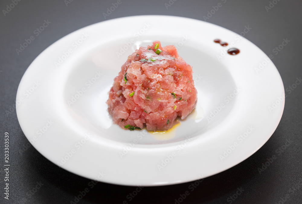 A delicious tartare of fresh Mediterranean tuna. Seasoned with extra virgin olive oil, chives, parsley and a few drops of orange juice. A delicious tartare of fresh Mediterranean tuna. Seasoned with extra virgin olive oil, chives, parsley and a few drops of orange juice.