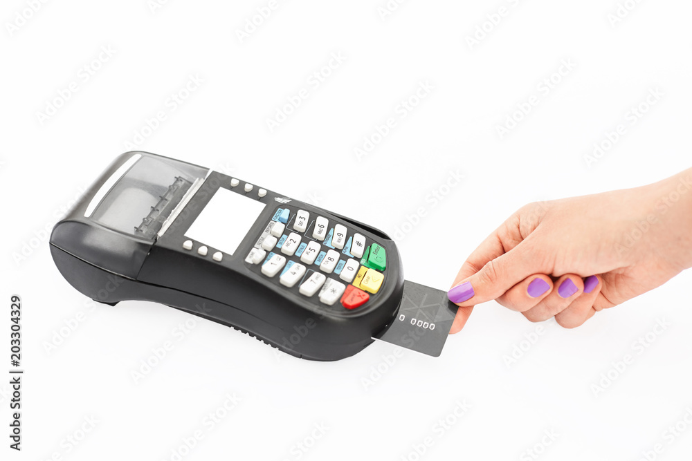 Woman pays with credit card via POS terminal in shop. Modern technologies and electronic payment concept. Hand swips magnetic card on POS terminal Woman pays with credit card via POS terminal in shop. Modern technologies and electronic payment concept. Hand swips magnetic card on POS terminal