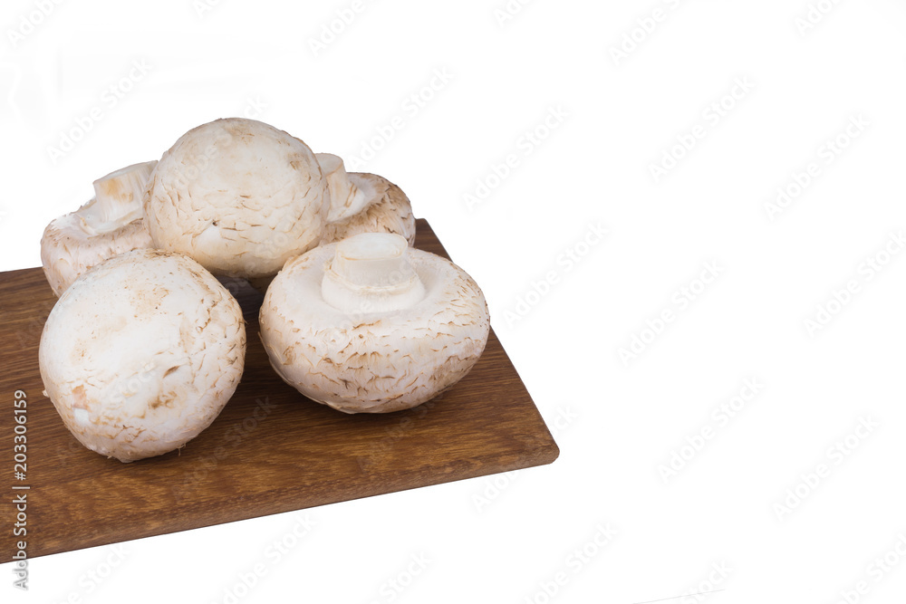 White mushrooms on a wooden cutting Board. Isolate on white background White mushrooms on a wooden cutting Board. Isolate on white background