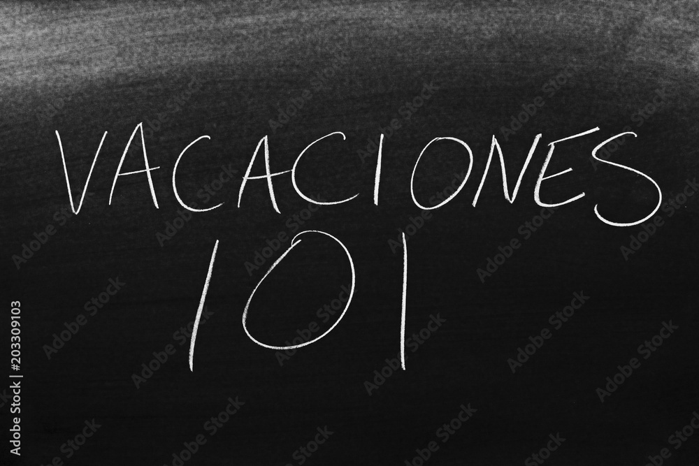 Obraz premium The words Vacaciones 101 on a blackboard in chalk. Translation: Vacation 101