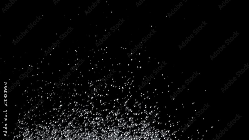 Excitement of the water throws hundreds of drops up. Black background. Slow motion