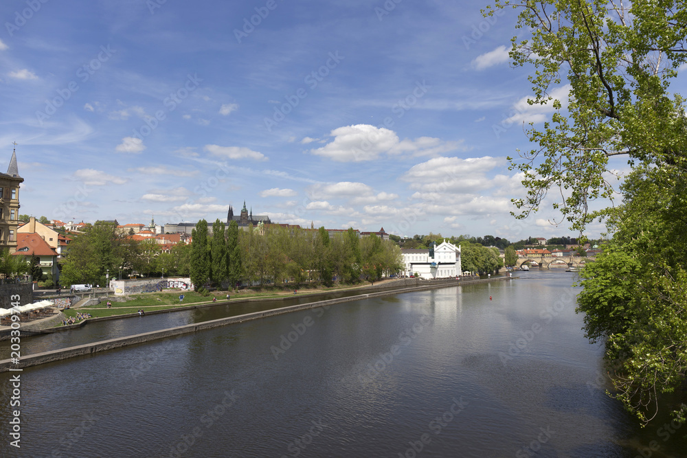 Spring green Prague Lesser Town with gothic Castle above River Vltava in the sunny Day, Czech Republic Spring green Prague Lesser Town with gothic Castle above River Vltava in the sunny Day, Czech Republic