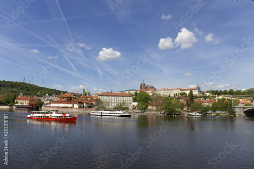 Spring green Prague Lesser Town with gothic Castle above River Vltava in the sunny Day, Czech Republic