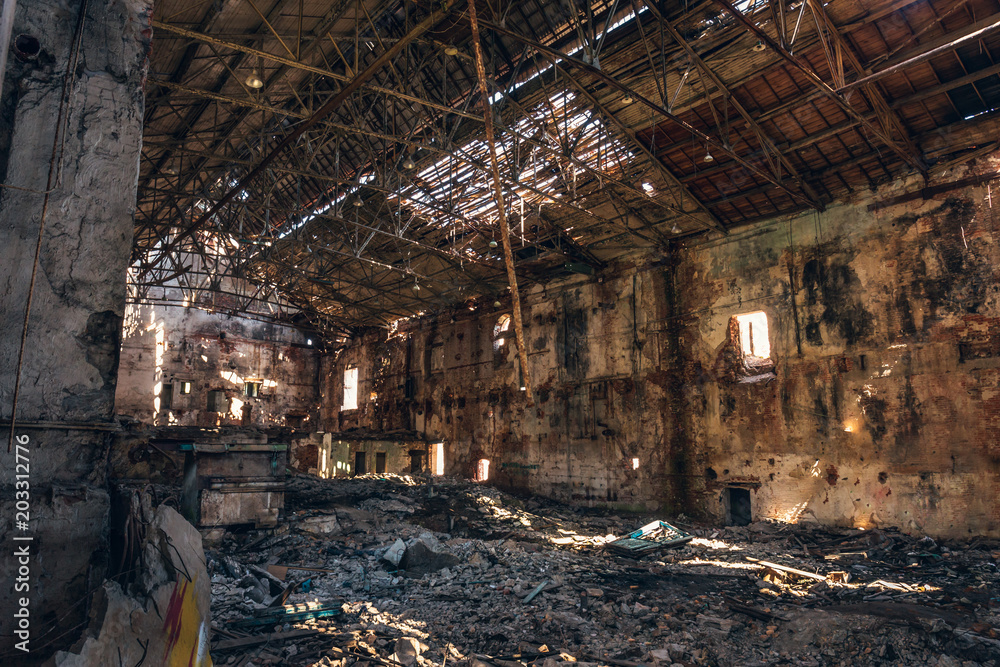 Ruined and abandoned dark creepy factory house building inside, industrial warehouse hall