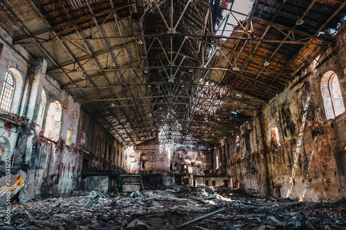 Ruined and abandoned dark creepy factory house building inside, industrial warehouse hall