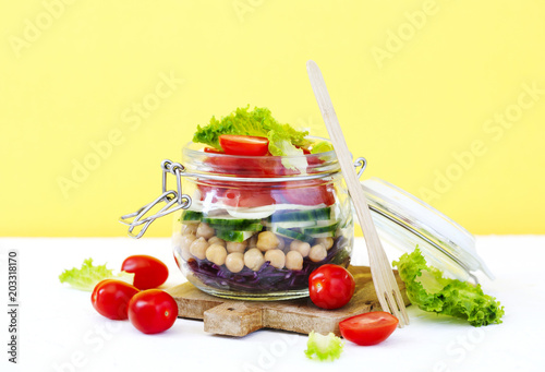Healthy vegetable and chickpea sprout vegan salad in glass jar. Healthy food concept.