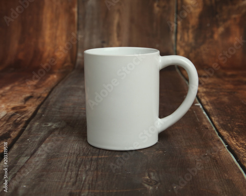 Blank white mug mockup photo on rustic wood