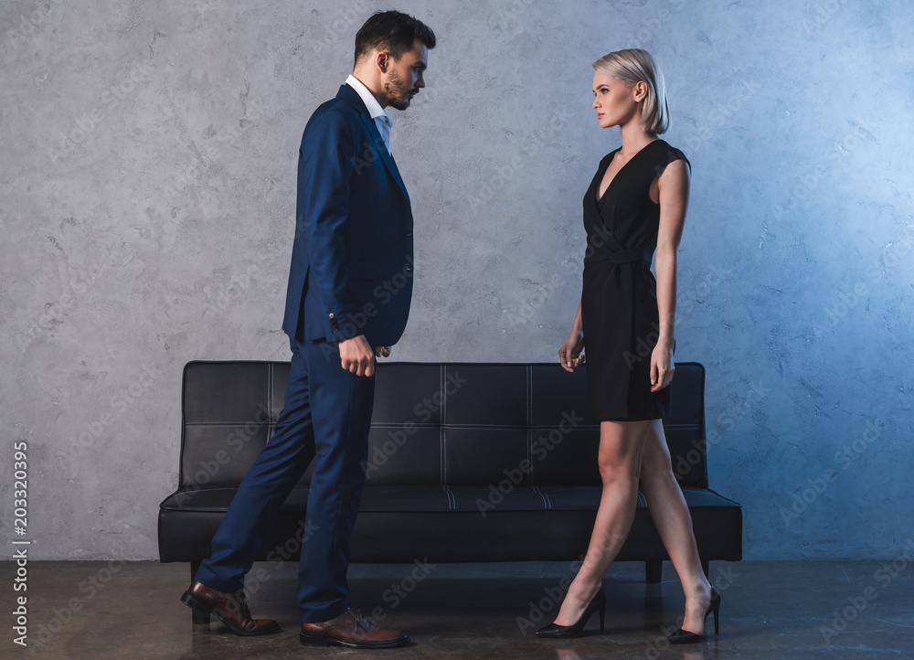 side view of beautiful sensual young couple looking at each other side view of beautiful sensual young couple looking at each other