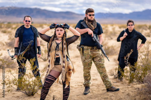 In a post-apocalyptic desert wasteland, a Queen of the Apocalypse leads her militia against the enemy. Armed to the teeth, who will win? Post-Apocalyptic inspired and shot in the California Desert photo