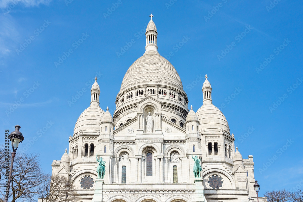 Panoramic view of Basilica of the Sacred Heart of Paris with blue cloudy sky in background (Paris, France, Europe).