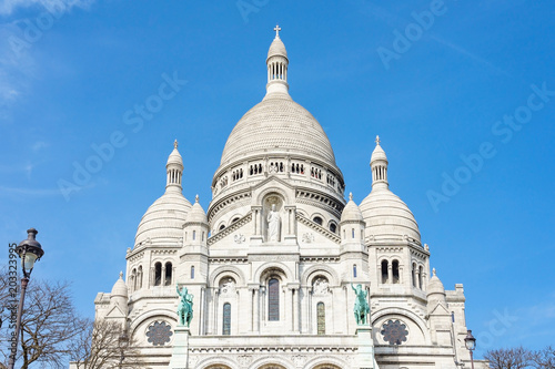 Panoramic view of Basilica of the Sacred Heart of Paris with blue cloudy sky in background (Paris, France, Europe).