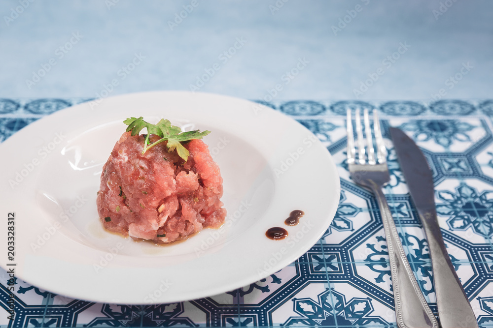 A delicious tartare of fresh Mediterranean tuna. Seasoned with extra virgin olive oil, chives, parsley and a few drops of orange juice. A delicious tartare of fresh Mediterranean tuna. Seasoned with extra virgin olive oil, chives, parsley and a few drops of orange juice.