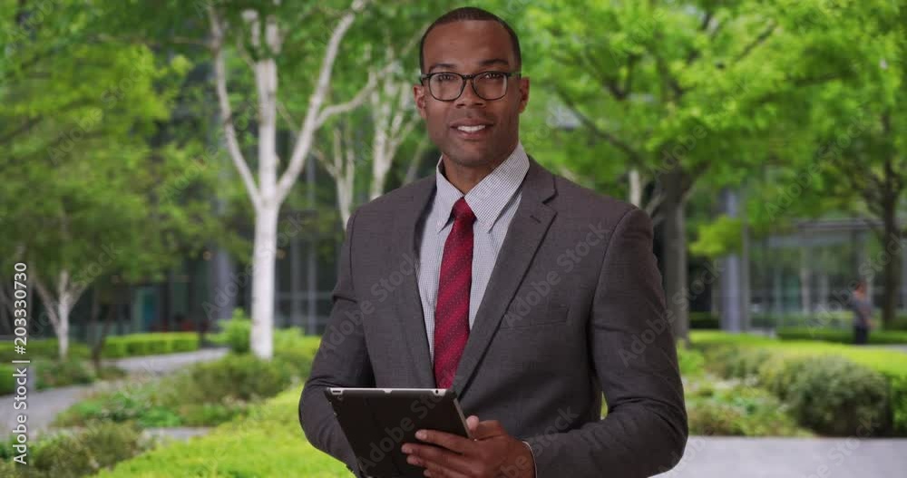 Handsome confident African professional posing with pride outside his place of work, Young aspiring African-American businessman looking at the camera confidently, 4k Handsome confident African professional posing with pride outside his place of work, Young aspiring African-American businessman looking at the camera confidently, 4k