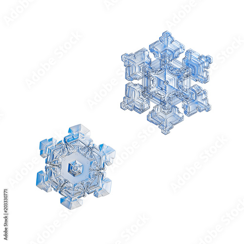 Two snowflakes isolated on white background. Macro photo of real snow crystals: small star plates with glossy relief surface, simple shapes, large central hexagons and complex inner patterns.