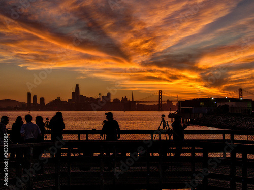 Photographers are taking a picture of sunset with San Francisco city silhouette © riderolga