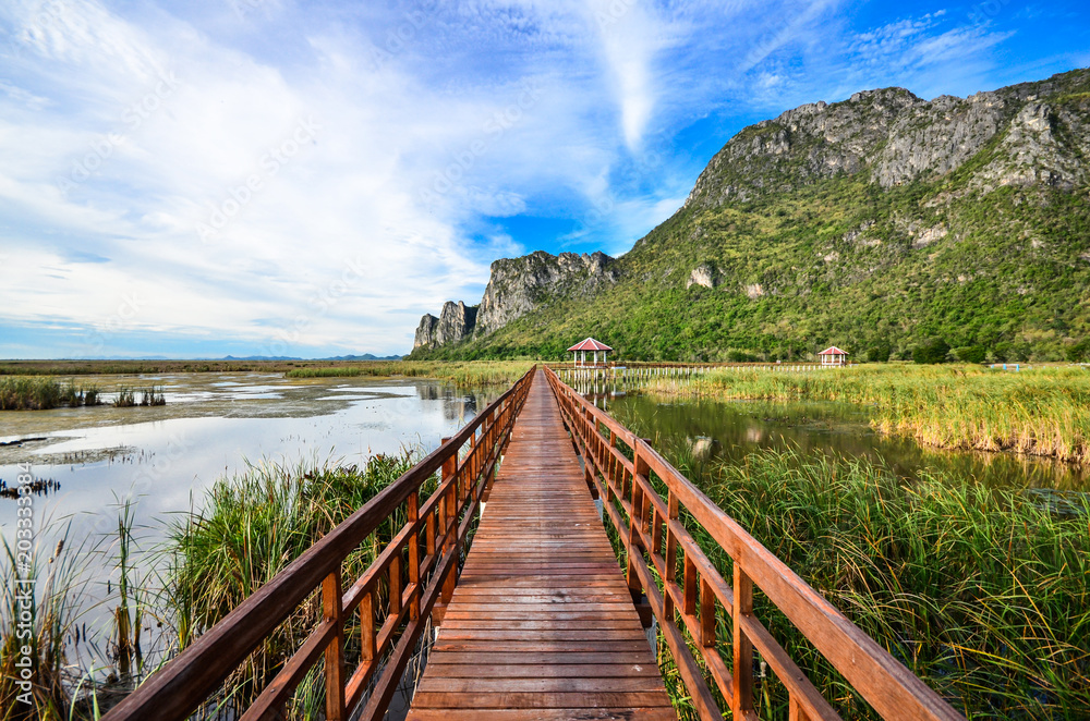 Red Wooden Bridge in lake under blue sky , Samroiyod national park, thailand