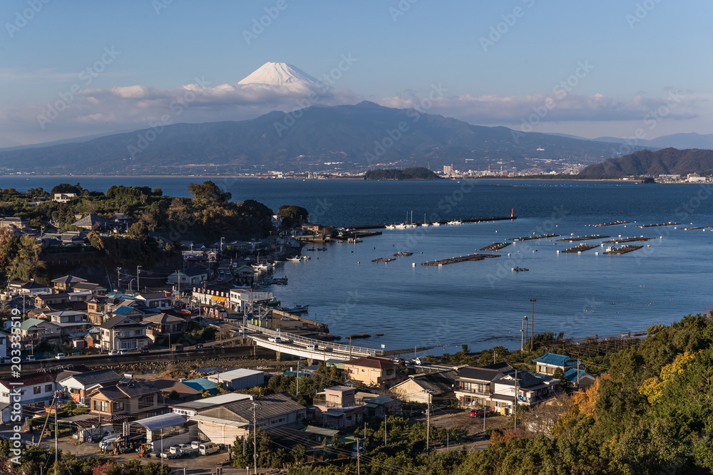 View of Izu town with Mountain Fuji and Suruga bay in winter evening.