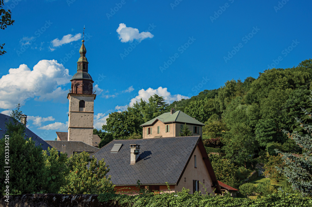 View of church steeple an evergreen forest in Conflans. An historical hamlet near Albertville. Located at the department of Haute-Savoie, southeastern France.