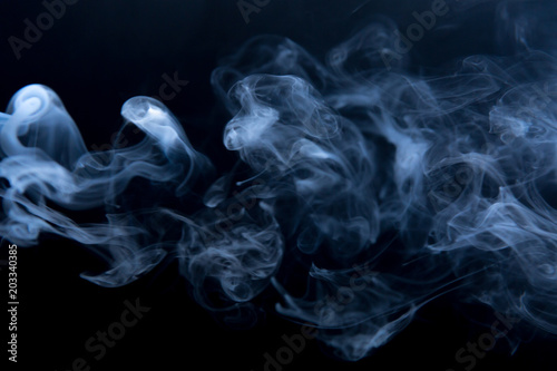 The clubs smoke on a black background, horizontal. Fluid effect.