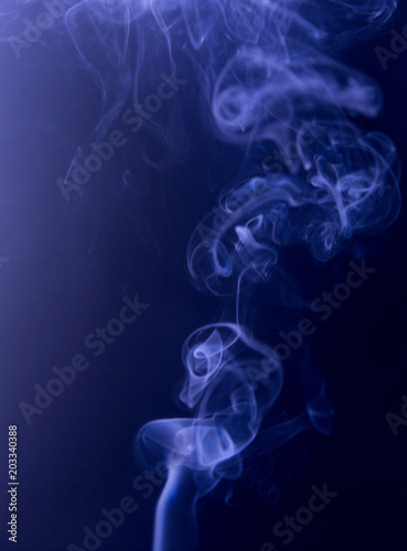 Texture of blue smoke clubs on a dark background.