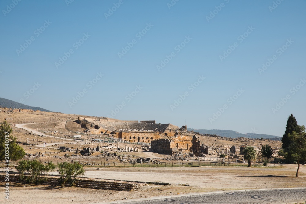beautiful architecture, rural road and mountains on horizon in pamukkale, turkey