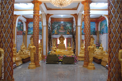 Golden statues of Buddha inside the Wat Chalong temple in Phuket, Thailand