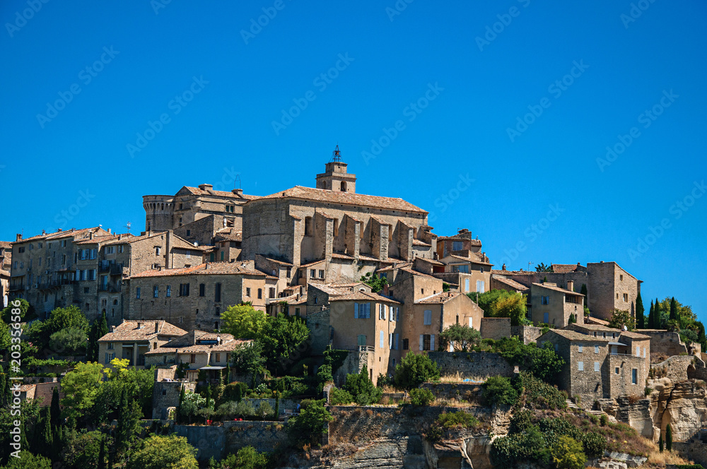 Close-up of the village of Gordes on top of a hill and under sunny blue sky. Located in the Vaucluse department, Provence region, in southeastern France