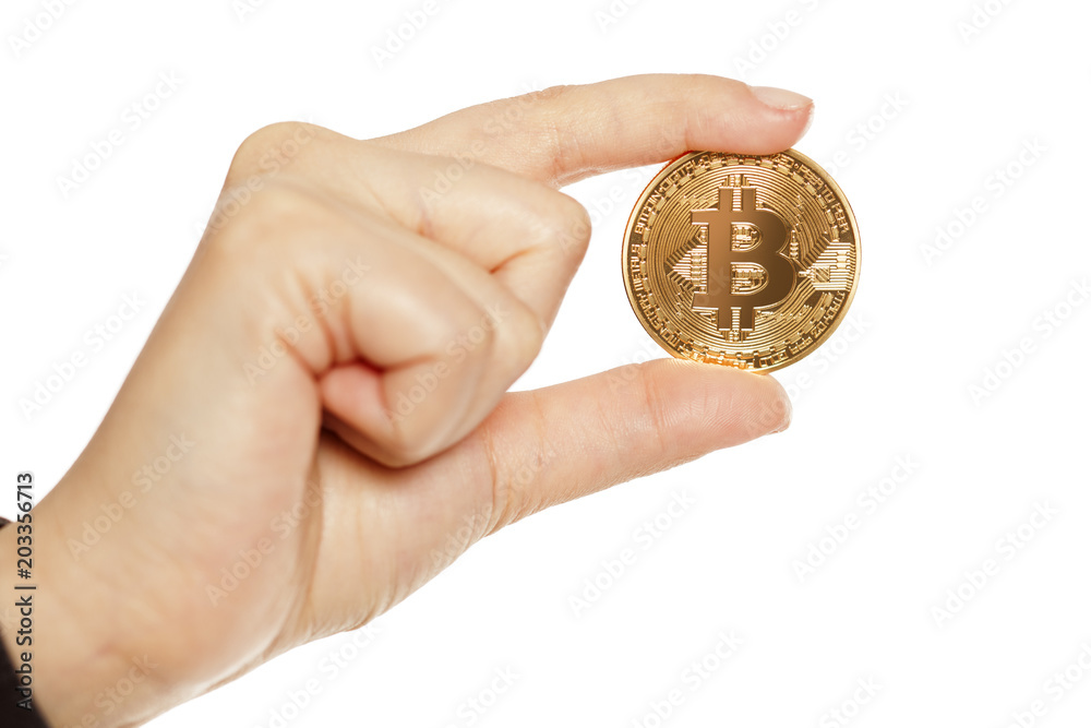 female hand holding golden bitcoin on white background female hand holding golden bitcoin on white background