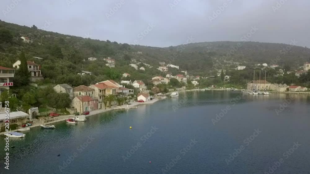 Aerial: Drone flying in front of main city bay. Lots of ancient old traditional fishing houses. Filmed on sailing trip in Adriatic sea in Croatia. Aerial: Drone flying in front of main city bay. Lots of ancient old traditional fishing houses. Filmed on sailing trip in Adriatic sea in Croatia.