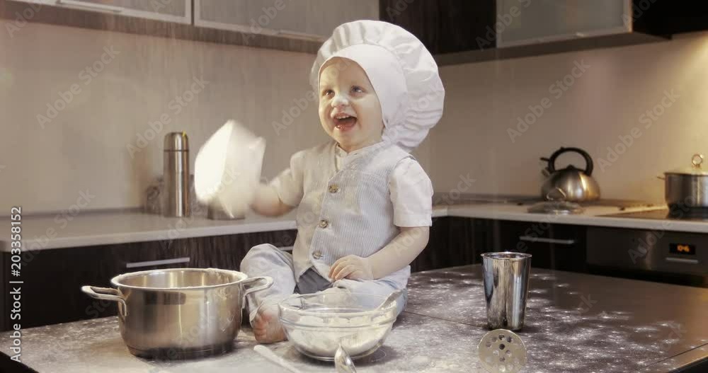 A funny chef cook plays with flour in the kitchen. A funny chef cook plays with flour in the kitchen.