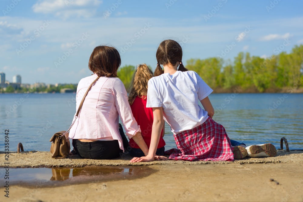 mother and two daughters. Watching the water