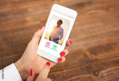 Woman using dating app and swiping user photos photo